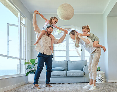 Buy stock photo Shot of a young family having fun together in the lounge at home