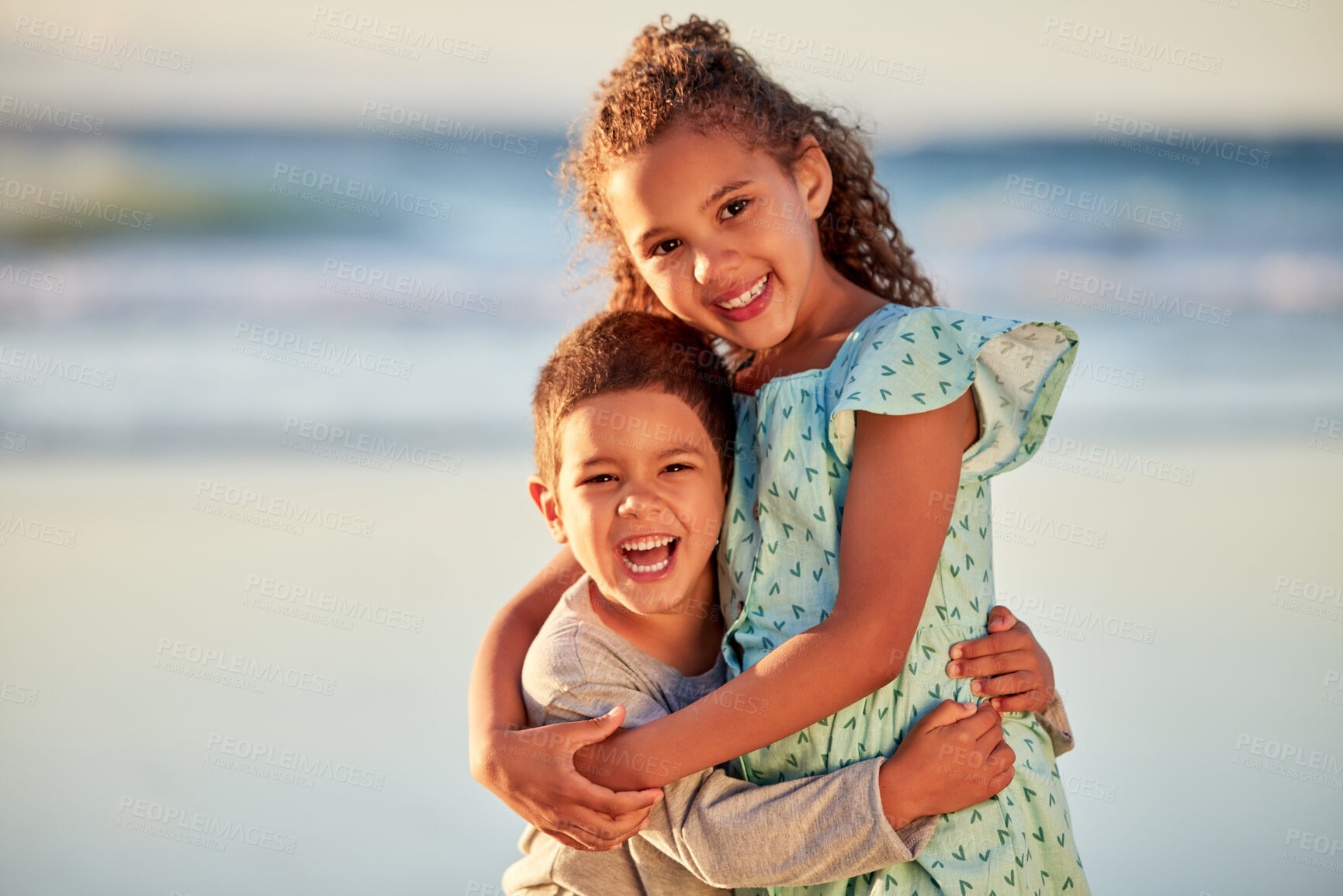 Buy stock photo Happy kids, portrait and hug on beach for vacation or holiday with smile, fun and outdoor summer travel. Boy, girl and children siblings laughing at sea for adventure, support and playing in ocean