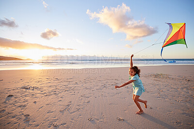 Buy stock photo Shot of a little girl playing with her kite on the beach
