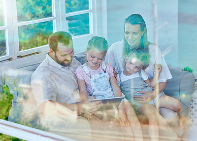 Buy stock photo Tablet, family and together on couch, online and reading of message, living room and parents. Home, man and woman with kids, window and sofa for mother, father and children or connection for games