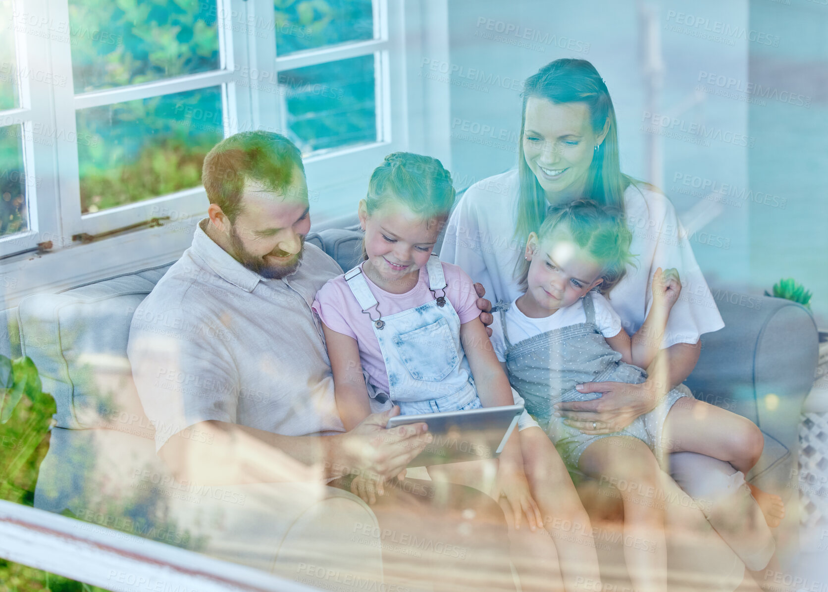 Buy stock photo Tablet, family and together on couch, online and reading of message, living room and parents. Home, man and woman with kids, window and sofa for mother, father and children or connection for games