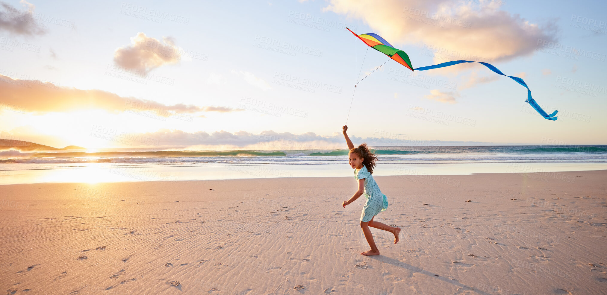 Buy stock photo Running, girl and kite at beach for sunset, adventure and vacation for summer in nature. Kid or child, exercise and fun with toys by ocean or sea for wellness, holiday or happiness and sand in Miami