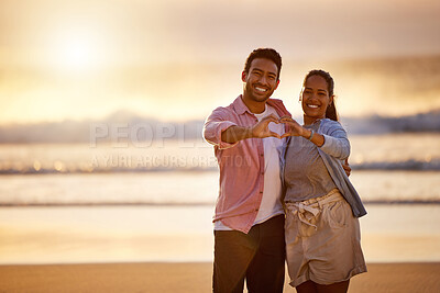 Buy stock photo Heart hands, sunset or happy couple at beach in portrait for love sign on vacation, valentines day or holiday. Care gesture, island or people at sea for bonding together or tropical romantic trip