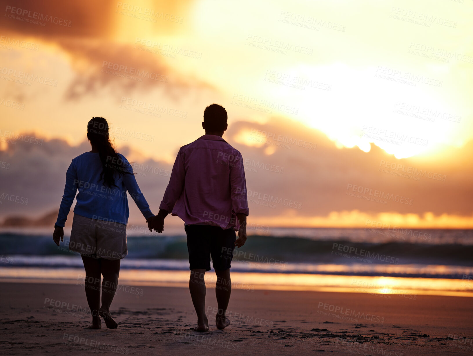 Buy stock photo Sunset, beach and couple with love, holding hands and romance with tropical island, vacation and honeymoon. Seaside, golden hour and man with woman, relationship and holiday for anniversary or travel