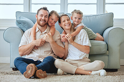 Buy stock photo Shot of a young family relaxing at home