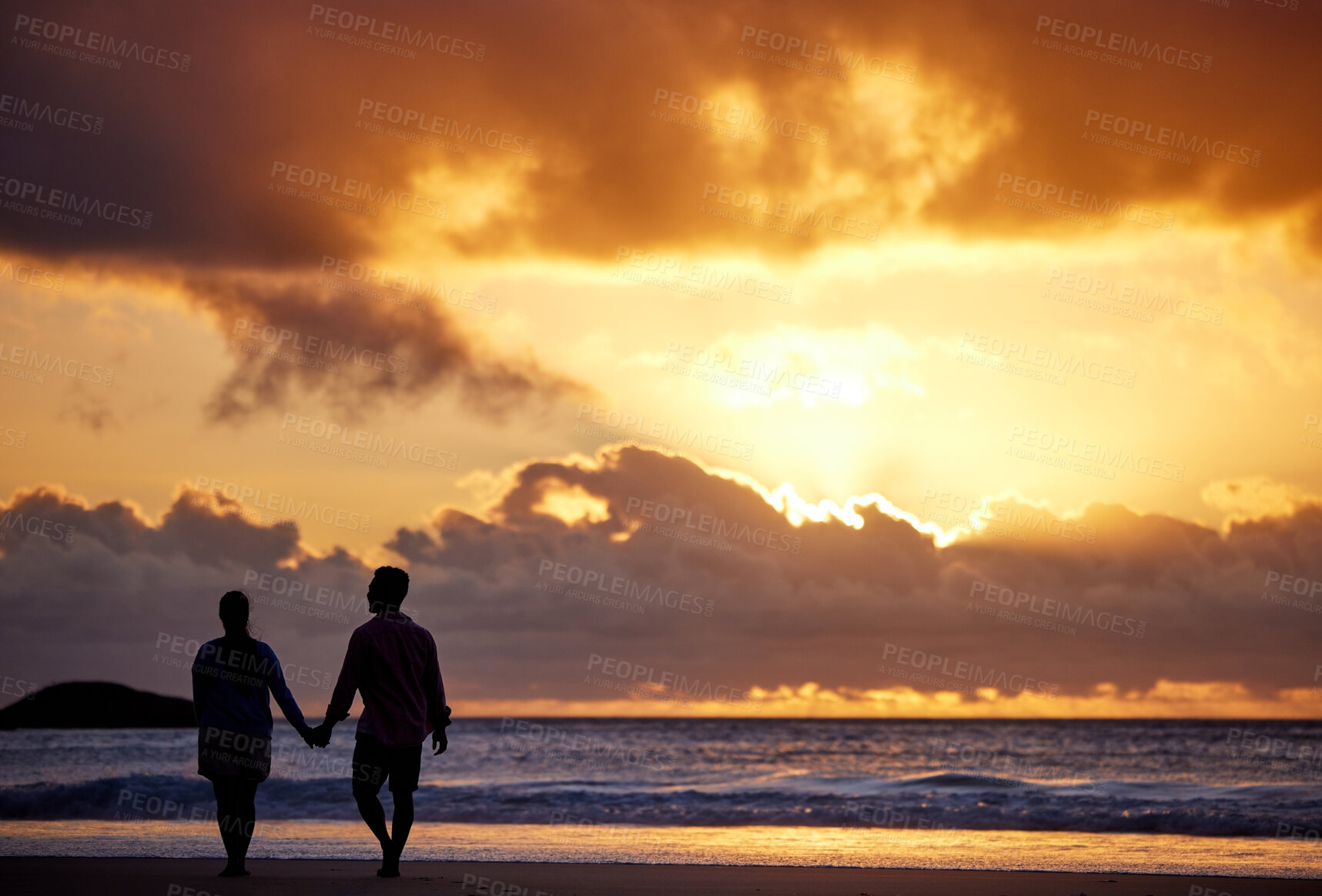 Buy stock photo Sunset, beach and couple with travel, holding hands and romance with tropical island, vacation and honeymoon. Seaside, golden hour and man with woman, relationship and holiday for anniversary or love