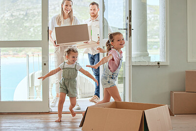 Buy stock photo Shot of a young family moving into their new home