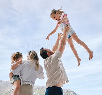 Buy stock photo Shot of a young family enjoying the outdoors together