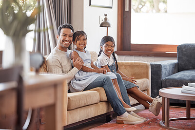 Buy stock photo Full length portrait of a handsome young man and his two daughters sitting on the sofa at home