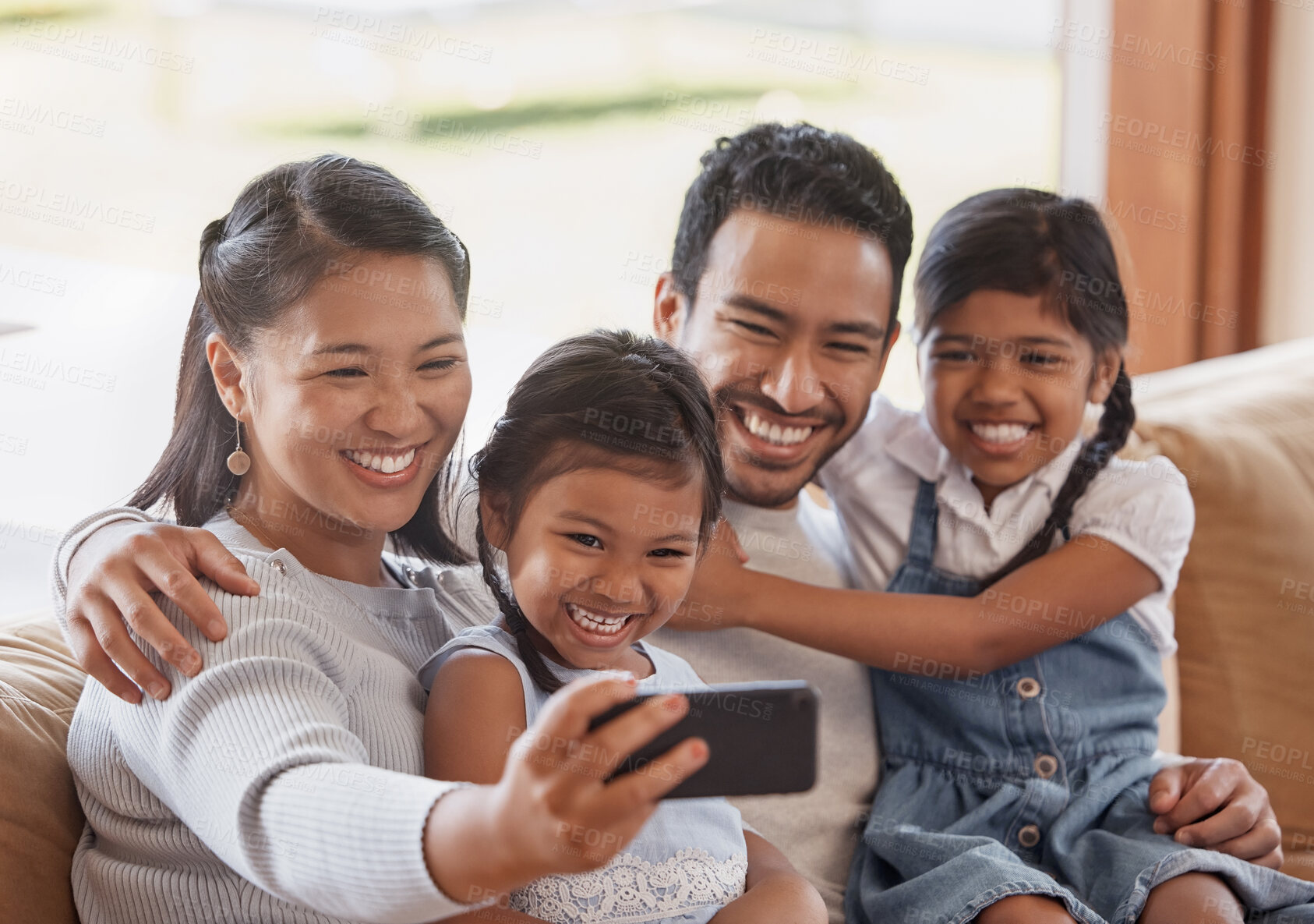 Buy stock photo Asian parents, selfie and happy family with kids on sofa for love, connection and children bonding together. Mom, dad and sisters take picture in home living room for memory, social media and support