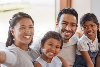 Buy stock photo Cropped portrait of an affectionate young family of four taking selfies on the sofa at home