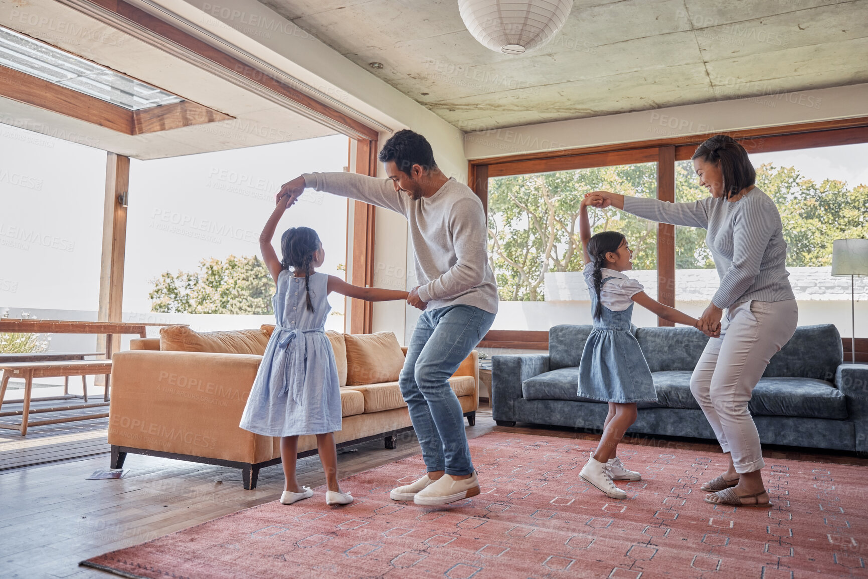 Buy stock photo Dancing, parents and girls in living room, home and bonding with children, teaching and lesson for youth. House, man and woman with kids, fun and games in weekend, learning and family together
