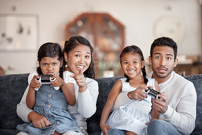 Buy stock photo Cropped portrait of an affectionate young family of four playing video games in the living room at home