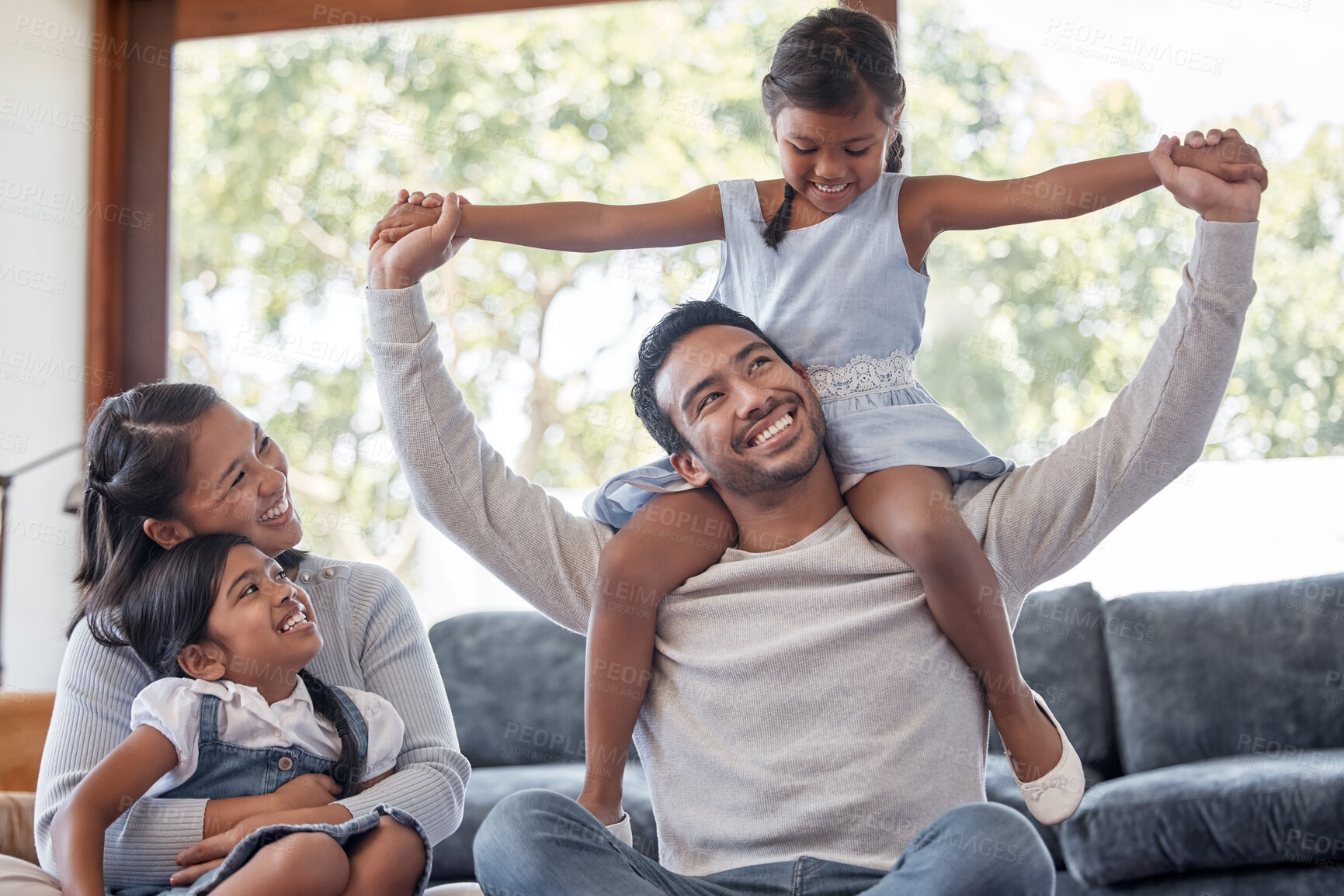 Buy stock photo Family, bonding and smile for love, living room and dad carrying daughter, embrace and break in house. Lounge, man and woman with girls, care and parents with children, mom and father in home