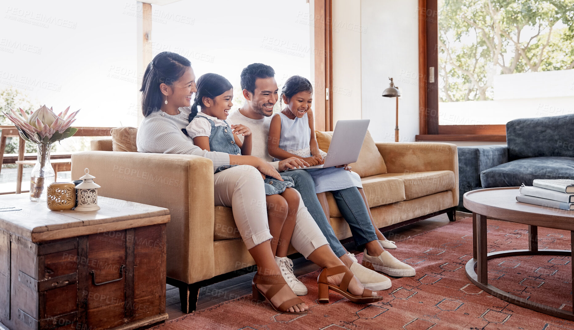Buy stock photo Funny, laptop and streaming with family on sofa in living room of home together for bonding or entertainment. Computer, movie or subscription service with mom, dad and children laughing in apartment