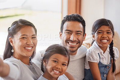 Buy stock photo Cropped portrait of an affectionate young family of four taking selfies on the sofa at home