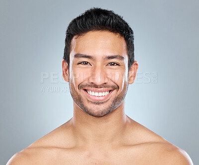 Buy stock photo Beauty, portrait and smile of masculine man in studio on gray background for cosmetic wellness. Dermatology, happy and skincare with face of confident person in bathroom for hydration or hygiene