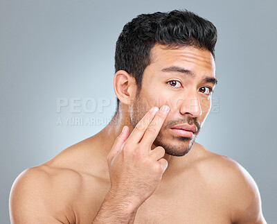 Buy stock photo Beauty, skincare and hand with man in studio, facial and wellness on white background. Dermatology, fingers and undereye cosmetics for male person, moisture and selfcare for grooming treatment 