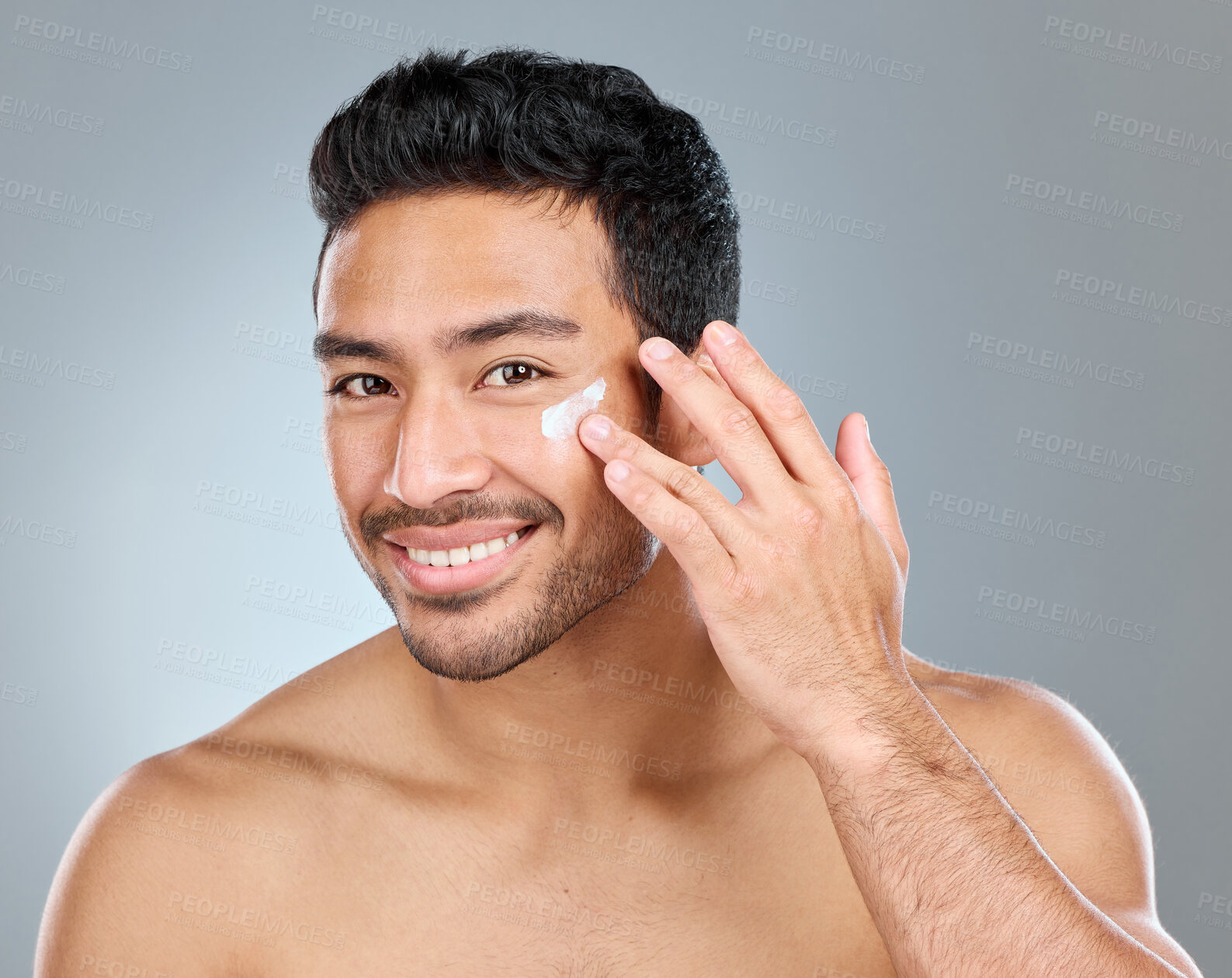 Buy stock photo Man, portrait and face cream in studio for skincare, hydration and skin tone with dermatology or cosmetology. Person, lotion and sunscreen on gray background for facial care, grooming and protection.