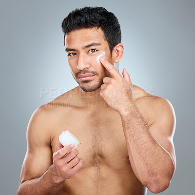 Buy stock photo Man, jar and portrait with cream in studio for skincare, hydration and skin tone with dermatology or cosmetology. Person, lotion and sunscreen on gray background for facial care, grooming and glow.