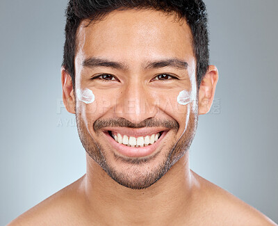 Buy stock photo Man, smile and portrait with cream in studio for skincare, hydration and skin tone with dermatology or cosmetology. person, lotion and sunscreen on gray background for facial care, grooming and glow.