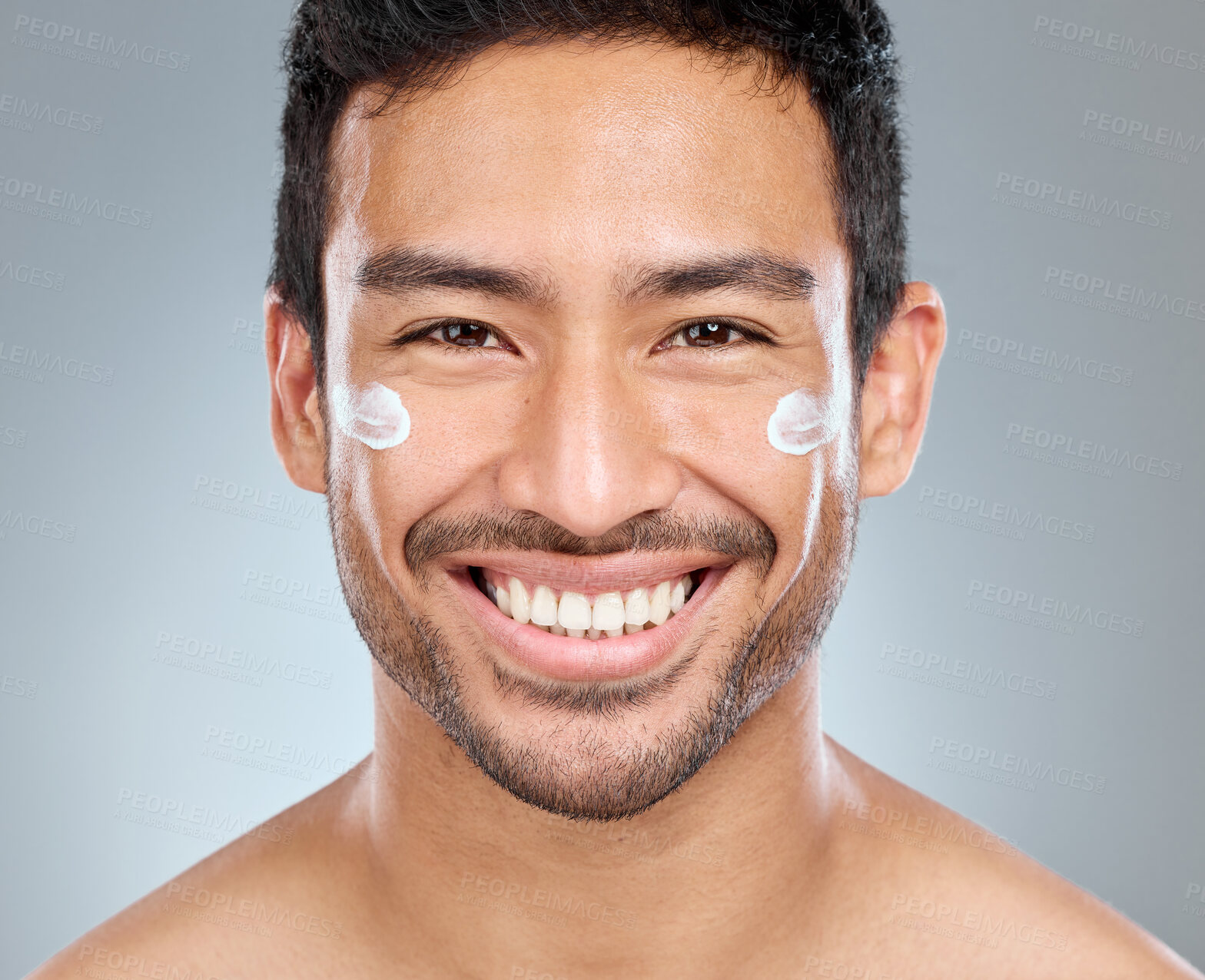 Buy stock photo Man, smile and portrait with cream in studio for skincare, hydration and skin tone with dermatology or cosmetology. person, lotion and sunscreen on gray background for facial care, grooming and glow.