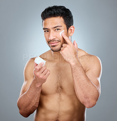 Buy stock photo Man, jar and portrait with face cream in studio for skincare, hydration and skin tone with dermatology or cosmetology. Person, lotion and product on gray background for facial care, grooming and glow