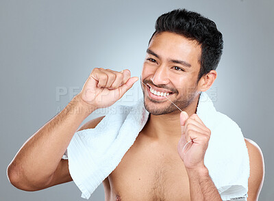 Buy stock photo Happy man, teeth and floss in studio for hygiene, cleaning and grooming for daily routine. Male person, thinking and dental care in morning for wellness, results and gingivitis by gray background