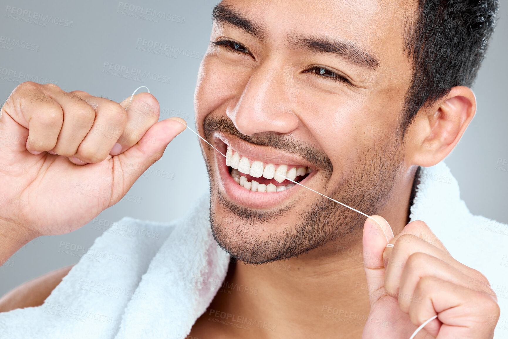 Buy stock photo Man, hands and teeth in studio for floss, hygiene and cleaning or grooming for daily routine. Male person, mouth and dental care in morning for wellness, results and gingivitis by gray background