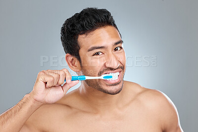 Buy stock photo Toothbrush, toothpaste and portrait of shirtless man in studio on gray background for cosmetic wellness. Brushing teeth, cleaning or hygiene with confident person in bathroom for dental and oral care