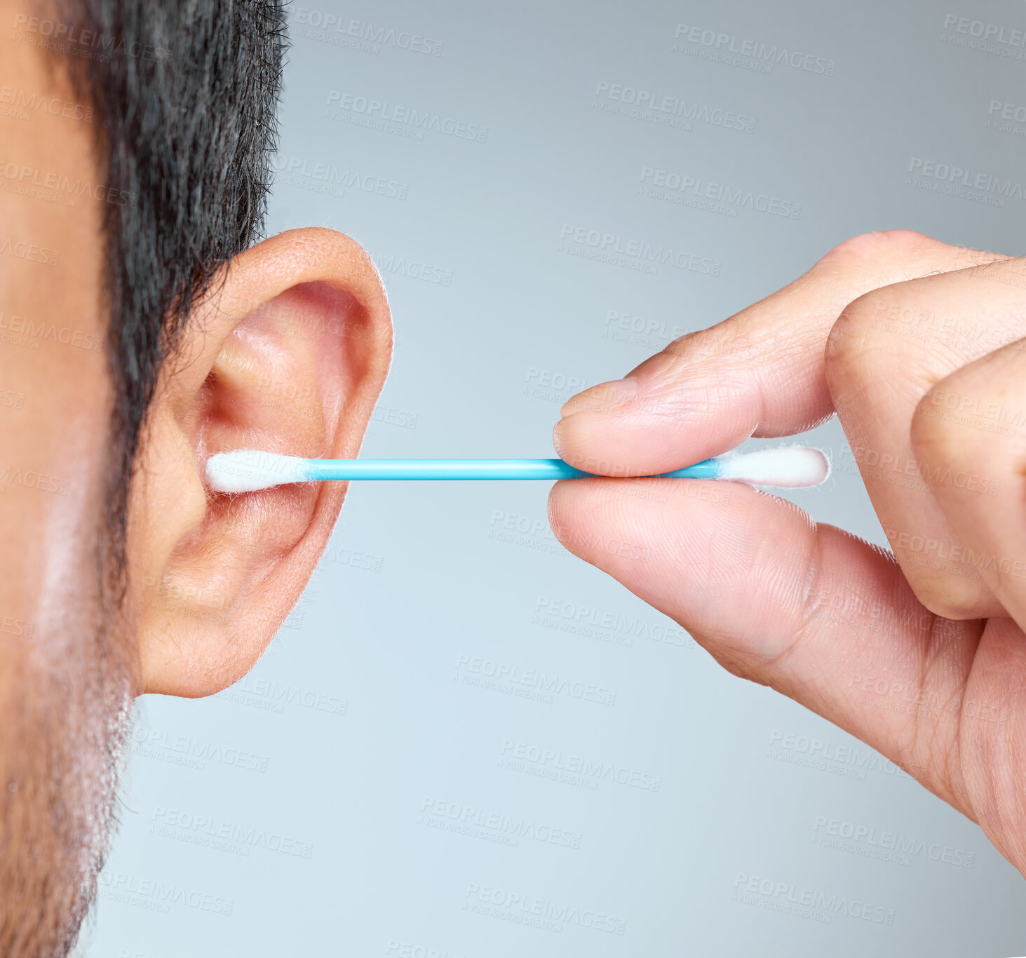 Buy stock photo Closeup, hand and cotton bud for ear and man, cleaning and grooming on white background. Hygiene, wax removal and product for male person, cleansing and routine for body care and hearing in studio