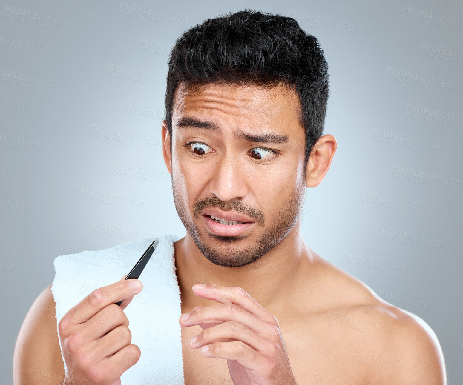 Buy stock photo Tweezer, hair removal and confused male person in studio, grooming and cosmetic on white background. Towel, scared emotion and male person for plucking, routine and eyebrow for selfcare cleaning