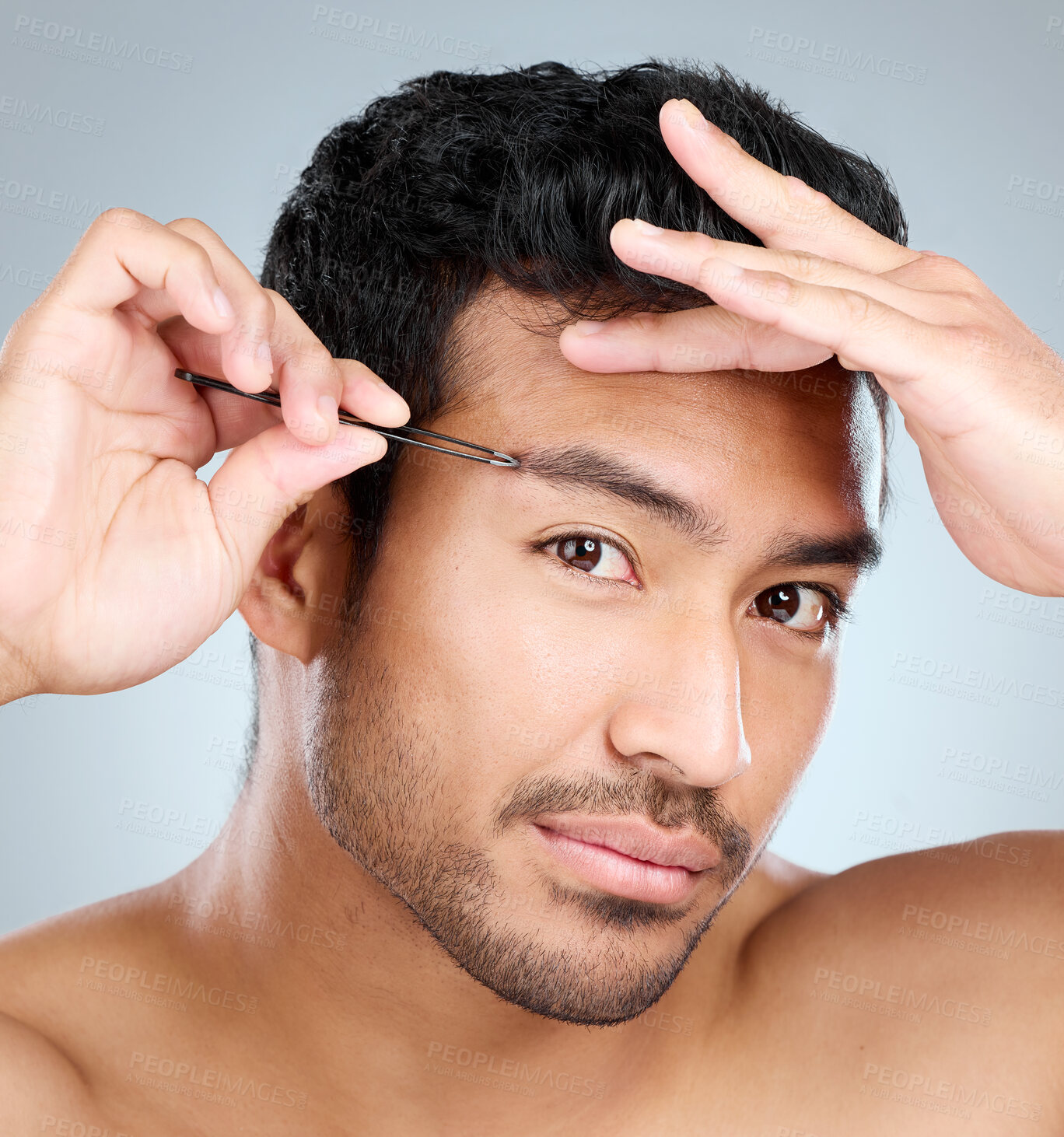 Buy stock photo Beauty, grooming and tweezers of masculine man in studio on gray background for cosmetic wellness. Dermatology, natural and skincare with face of person plucking eyebrows in bathroom for hygiene