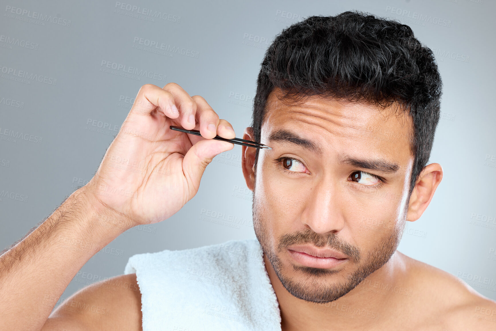 Buy stock photo Man, thinking and tweezers by eyebrow in studio for grooming, facial epilation and wellness or skincare. Male person, cosmetic tool and product for hair removal, gray background and hygiene routine.