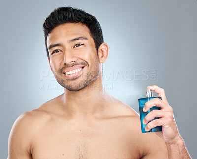 Buy stock photo Man, apply cologne and bottle in studio, body care and perfume spray on gray background. Male person, deodorant essence and container for aroma or fresh scent, clean smell and shirtless for fragrance