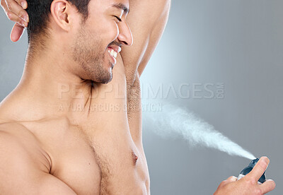 Buy stock photo Deodorant, health and man spray armpit against a gray studio background. Wellness, care and smile of topless model with underarm product for grooming, clean skin and routine for body hygiene