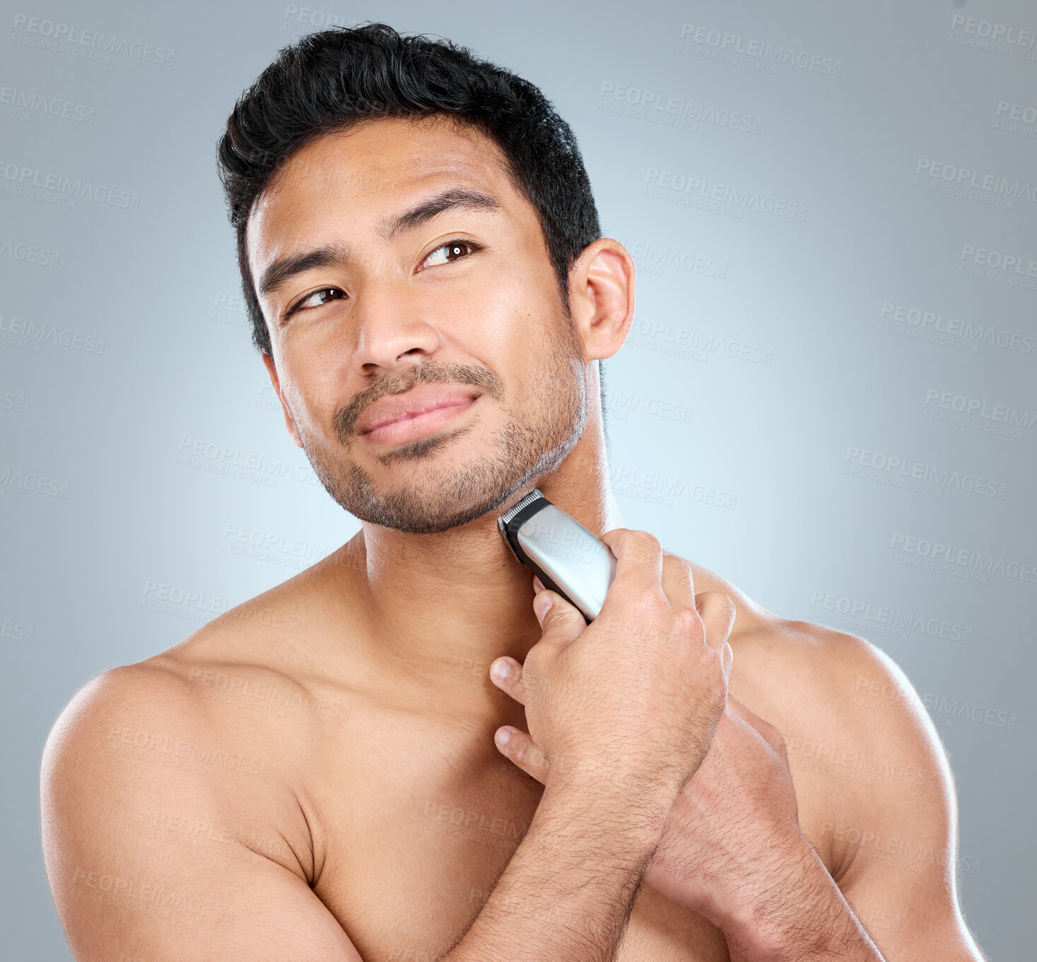 Buy stock photo Electric, razor and man grooming in studio for beard or maintenance, facial epilation and wellness or skincare. Person, cosmetic tool and shaving for hair removal, gray background and hygiene routine