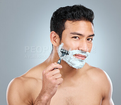 Buy stock photo Beauty, portrait and razor with masculine man in studio on gray background for cosmetic wellness. Dermatology, foam or soap for skincare with face of confident person shaving in bathroom for hygiene