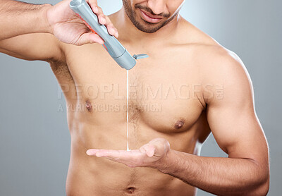 Buy stock photo Hands, skincare and lotion with shirtless man in studio on a gray background for his grooming routine. Beauty, body and dermatology for model, moisturizing and apply with antiaging cream for skin