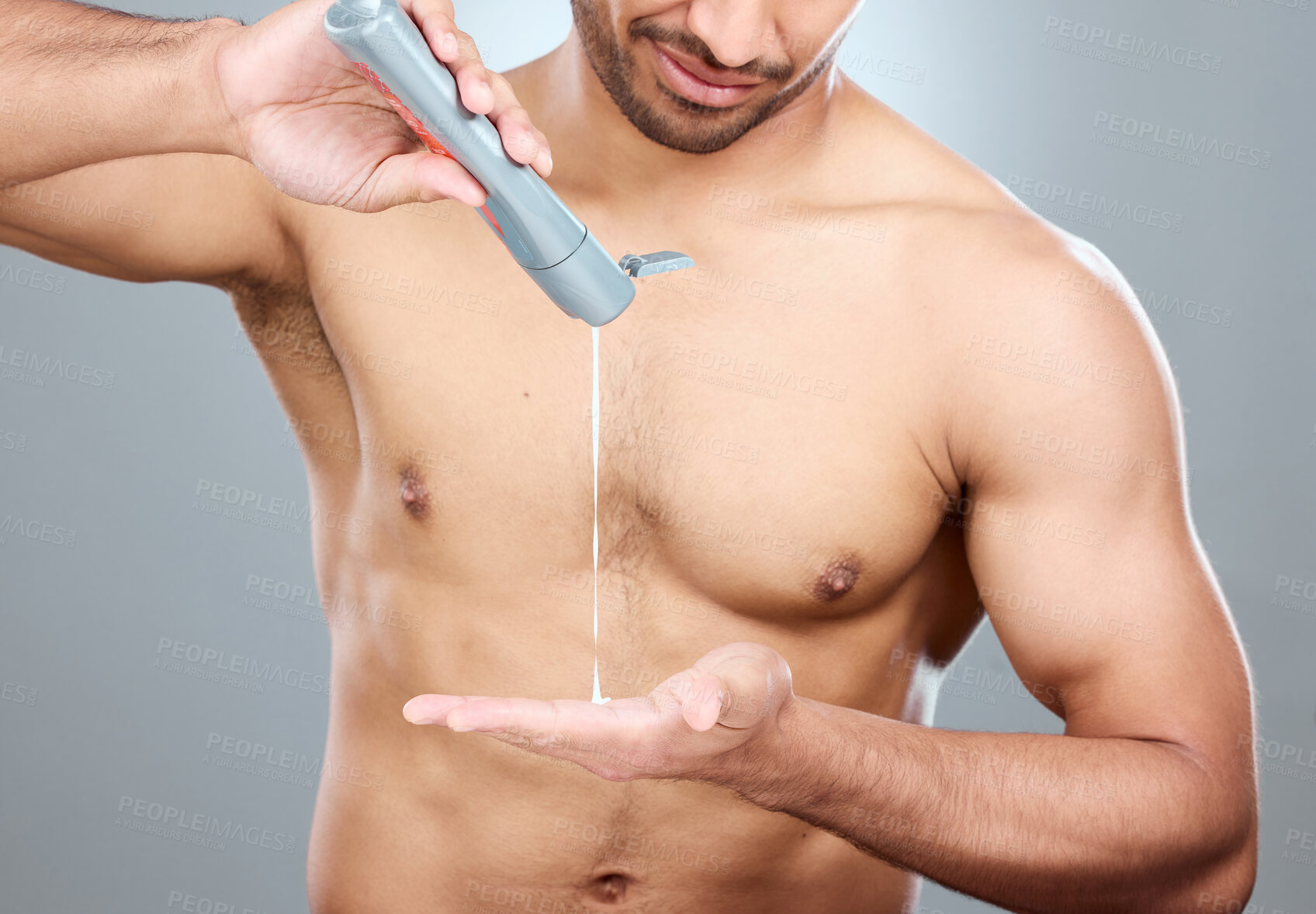 Buy stock photo Hands, skincare and lotion with shirtless man in studio on a gray background for his grooming routine. Beauty, body and dermatology for model, moisturizing and apply with antiaging cream for skin