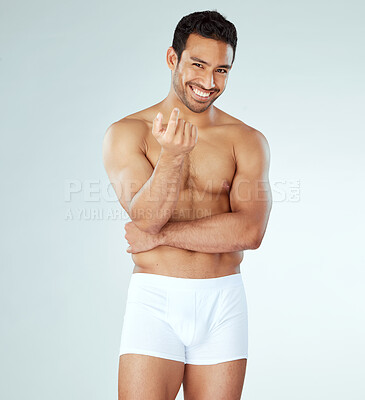 Buy stock photo Shot of a muscular young man posing against a studio background