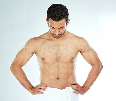 Buy stock photo Body, cleaning and asian man in a towel in studio for wellness, hygiene or grooming on white background. Stomach, chest and male model checking fitness results, progress or sixpack muscle development