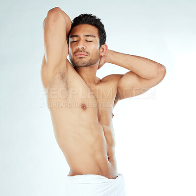 Buy stock photo Shot of a young man posing against a studio background