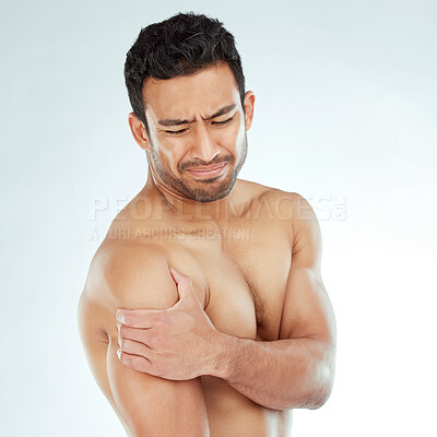 Buy stock photo Shoulder pain, stress and fitness with man in studio for arthritis, tension or nerve problem on white background. Arm, injury and face of Asian model with osteoporosis, fibromyalgia or sport accident