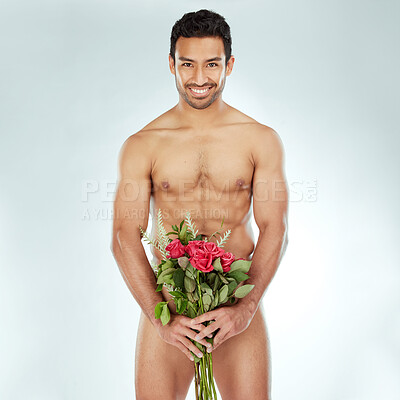 Buy stock photo Shot of a man covering his genitals with a bouquet of roses against a studio background