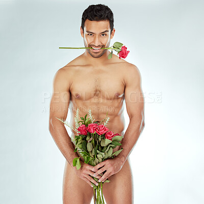 Buy stock photo Shot of a man covering his genitals with a bouquet of roses against a studio background