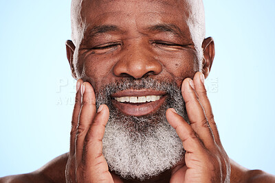 Buy stock photo Cropped shot of a handsome mature man posing in studio against a blue background