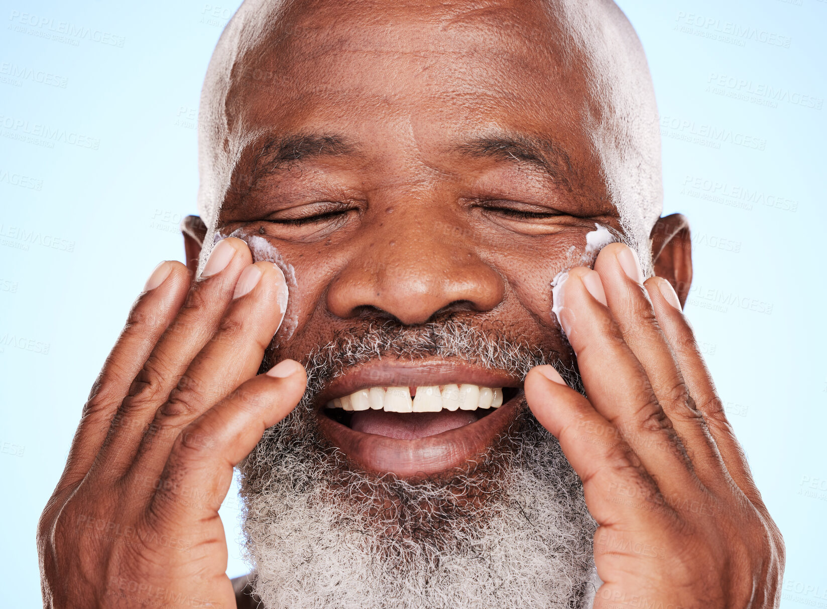 Buy stock photo Happy, cream and senior African man in studio for dermatology, wellness and sunscreen. Pride, black male person and healthy glow, shine or moisturizer by blue background for retirement or anti aging