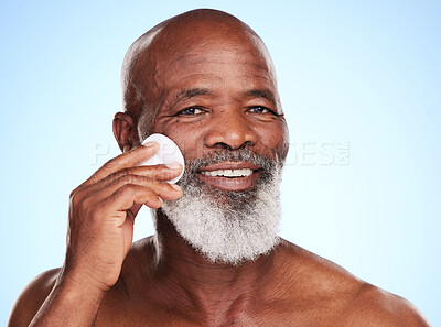 Buy stock photo Cropped portrait of a handsome mature man posing in studio against a blue background