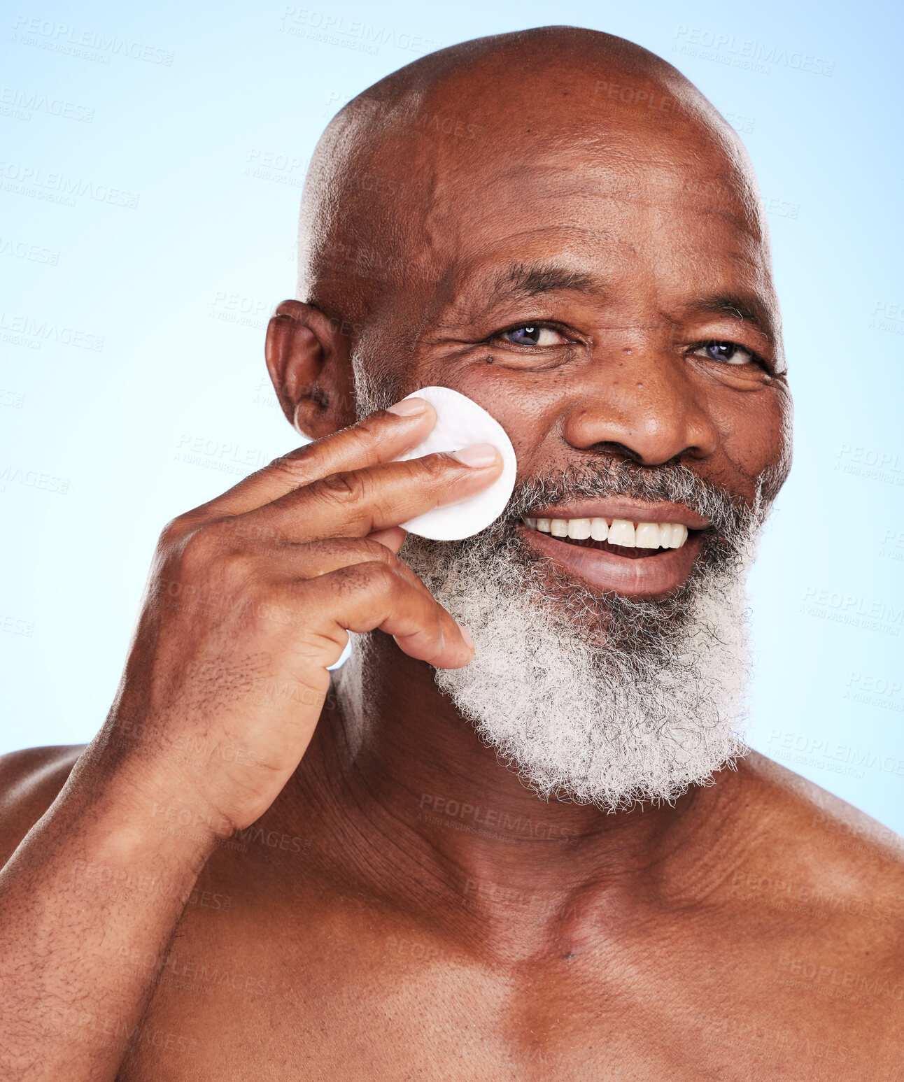 Buy stock photo Black man, face and skincare in studio with cotton pad for cleaning, toner and skin moisturizer. Mature person, portrait and dermatology on blue background with beauty swab for wellness or treatment